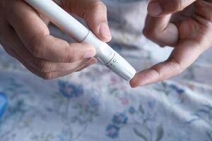 A person actively utilizing a specialized device for the purpose of glucose monitoring efficiently photo