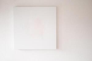 A Minimalist Empty Canvas Displayed on a White Wall, Perfect for Artistic Backgrounds photo