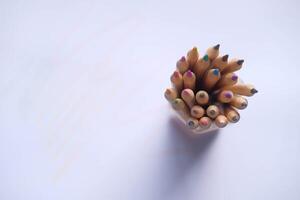 A Collection of Colorful Pencils Neatly Arranged Inside a Container Against a White Background photo