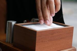 hand pull out a piece of tissue from tissue paper box photo