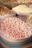 An Impressive Variety of Different Raw Beans and Legumes on Display in a Market Booth photo