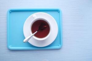 A delightful Cup of Tea gracefully placed on a lovely Blue Tray, ready to be enjoyed photo
