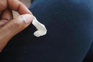 Detailed instructions for effectively removing chewing gum from fabric, with closeup view focus photo