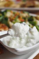 fresh yogurt in a bowl on table photo