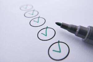 Place Check Marks on Paper Using a Marker to Indicate Task Completion Effectively and Clearly photo
