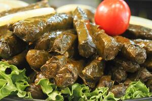 Traditional dolma grape leaves on a plate photo