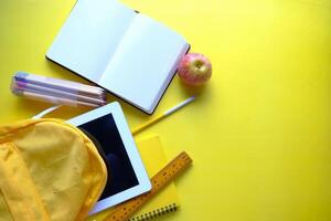Brightly Colored School Supplies Arrayed on a Vibrant Yellow Background for Educational Use photo