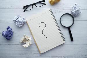 Engaging in the Exploration of Ideas Curiosity Illustrated through a Notebook and a Question Mark photo