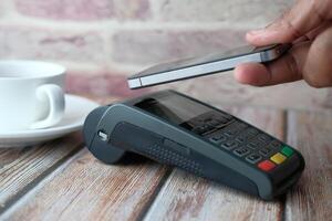Executing a Mobile Payment Transaction by utilizing a Card Reader while purchasing Coffee photo