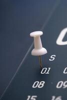 A CloseUp Image of a Pushpin Placed on a Calendar Date Highlighting January 1st photo