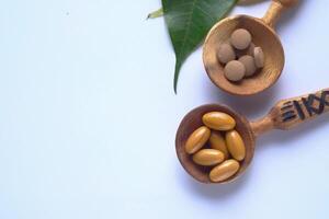 Natural Dietary Supplements Presented in Charming Wooden Spoons with an Accompanying Leaf photo