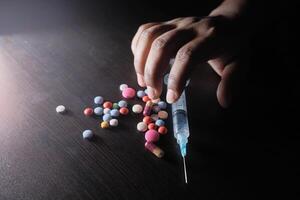 The use of intravenous drugs, combined with different types of pills and syringes, photo