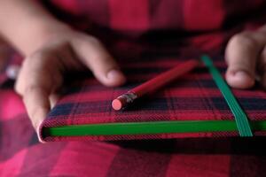 A Cozy Notebook and a Pencil Perfectly Resting on a Beautiful and Rustic Background Setting photo