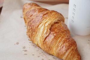 fresh baked croissant on plate with copy space photo