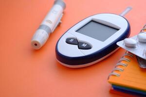 Managing Diabetes Effectively Tools and Medication Displayed on a Bright Orange Background photo