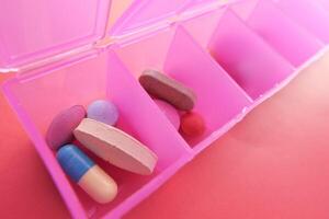 A Bright and Colorful Pill Organizer Featuring an Array of Different Medications and Supplements photo