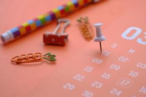 A collection of vibrant and colorful stationery items placed on a stylish calendar background photo