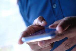 An Intimate CloseUp View of Hands Actively Using a Smartphone for Communication and Connectivity photo