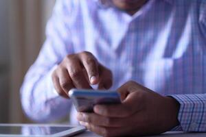 Businessman Engaged in Using Smartphone for Effective Communication or Workrelated Tasks photo