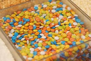 A Colorful and Diverse Assortment of Candy Coated Chocolates beautifully arranged in a Display photo