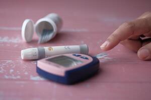 Diabetes Management Utilizing a Blood Glucose Meter along with Essential Testing Supplies photo
