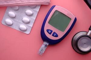 Diabetes monitoring tools include glucometers, medications, and stethoscopes for care photo