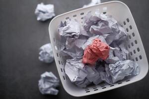 A visually appealing assortment of Colorful Crumpled Paper in a Basket on a Dark Background photo