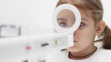 A little girl enjoys an engaging vision game on state-of-the-art ophthalmic equipment. The Rainbow system enhances eyesight in a comfortable and welcoming environment. video
