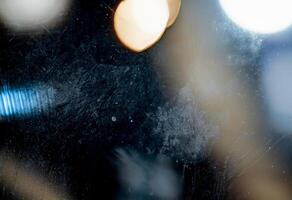 Close-up abstract texture with frosted surface, soft light streaks, and subtle rainbow reflection. photo
