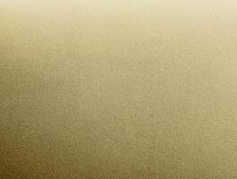 Close-up of golden sandpaper texture with a fine, grainy surface, perfect for backgrounds and design elements. photo