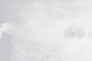 Soft white smoke or mist floating on a light background, perfect for abstract, atmospheric, or ethereal designs. photo