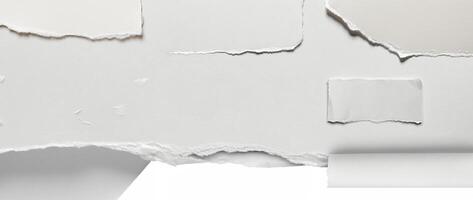 Close-up of a torn edge of white paper with rough texture, isolated on a clean white background. photo