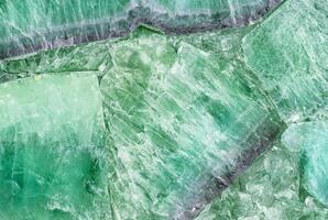Close-up of green crystal stone texture, ideal for natural patterns, backgrounds, or decorative elements. photo