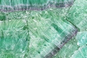 Close-up of green crystal stone texture, ideal for natural patterns, backgrounds, or decorative elements. photo