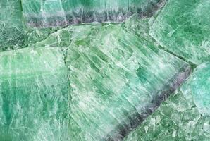 Close-up of green crystal stone texture, ideal for natural patterns, backgrounds, or decorative elements. photo