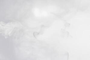 Soft white smoke or mist floating on a light background, perfect for abstract, atmospheric, or ethereal designs. photo