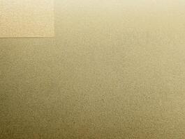 Close-up of golden sandpaper texture with a fine, grainy surface, perfect for backgrounds and design elements. photo