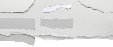 Close-up of a torn edge of white paper with rough texture, isolated on a clean white background. photo