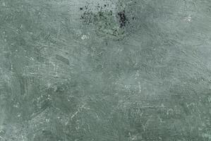 Close-up of rough green textured surface with visible scratches and brush marks, ideal for backgrounds. photo