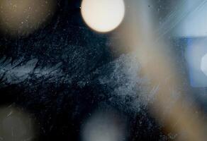 Close-up abstract texture with frosted surface, soft light streaks, and subtle rainbow reflection. photo