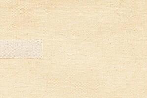 Beige fabric with visible woven texture, seamless material background, textile pattern close-up. photo