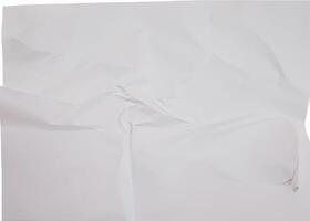 A crumpled white paper sheet with visible wrinkles and folds, isolated on a plain white background. photo
