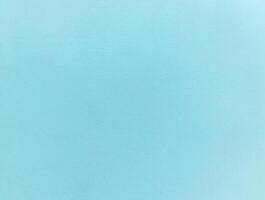 Minimalist light blue textured background with a subtle grain, ideal for design projects or as a backdrop. photo