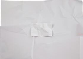 A crumpled white paper sheet with visible wrinkles and folds, isolated on a plain white background. photo