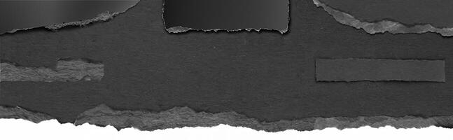 Close-up texture of torn black paper with a rough edge, perfect for background, design, or collage elements. photo