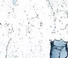 High-speed water droplets suspended in mid-air on a white background, freeze-frame capture. photo