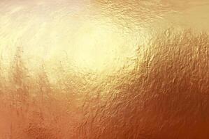 Close-up of textured gold surface with a metallic shine, ideal for use in luxury backgrounds, design, and creative projects. photo