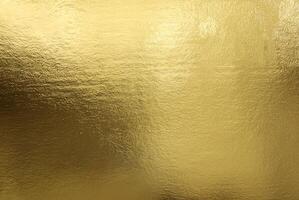 Shiny gold foil texture with a smooth, reflective surface ideal for backgrounds or luxurious designs. photo