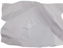 A crumpled sheet of white paper with deep folds and wrinkles, isolated on a plain white background. photo