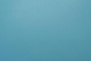 Simple minimalist blue textured background with a smooth surface, perfect for design projects. photo
